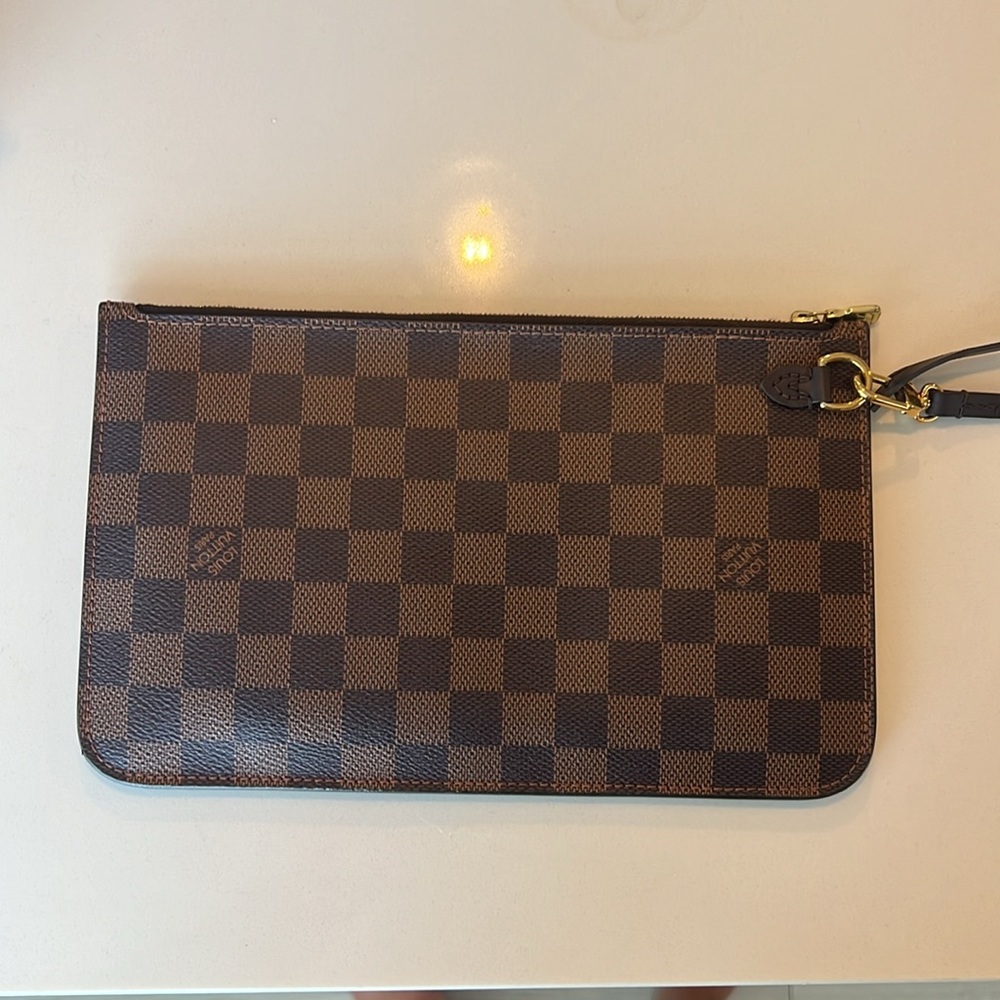 LIKE NEW Neverfull MM wristlet.